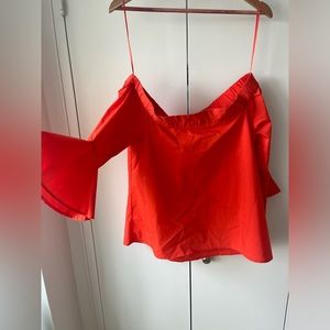 Off the shoulders orange long flared sleeved shirt.